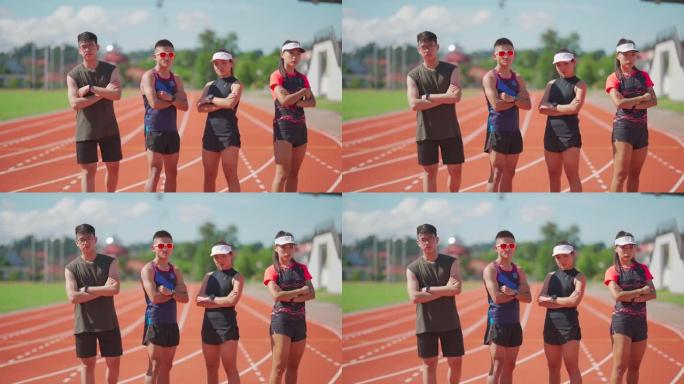 亚洲中国自信运动员运动队以冷静的态度看着镜头，早上站在全天候的田径体育场上
