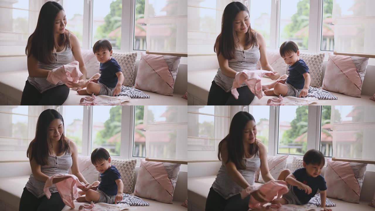 亚洲中国孕妇为她的新生婴儿准备婴儿布和婴儿室做准备