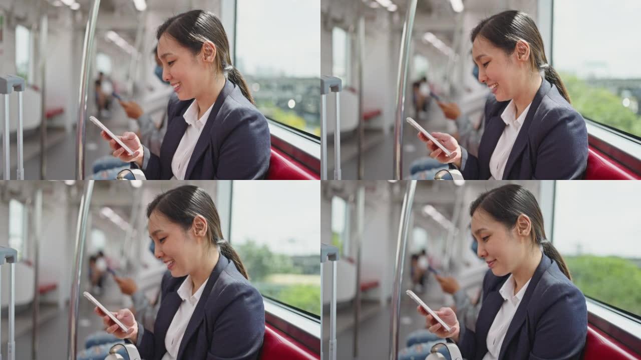 在地铁上使用智能手机的女商人