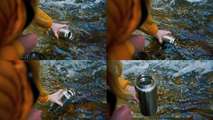 女人用森林中的溪流水填充热水瓶