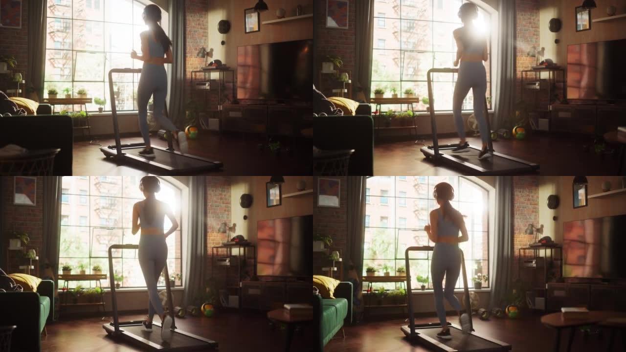 美丽的运动运动女人在家里的健身房跑步机上跑步。精力充沛的锻炼: 女性在听播客或耳机音乐时训练。带窗户