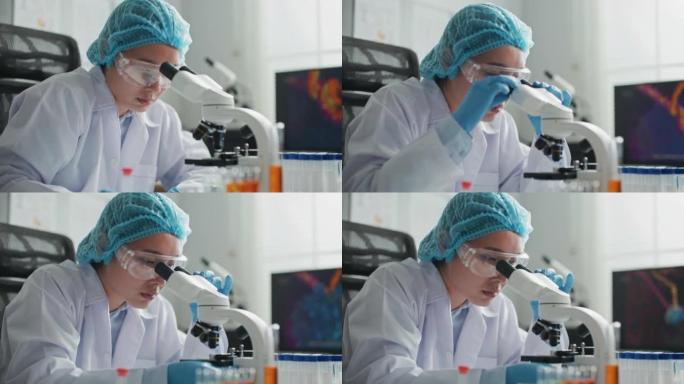 医学科学实验室科学家在显微镜下观察