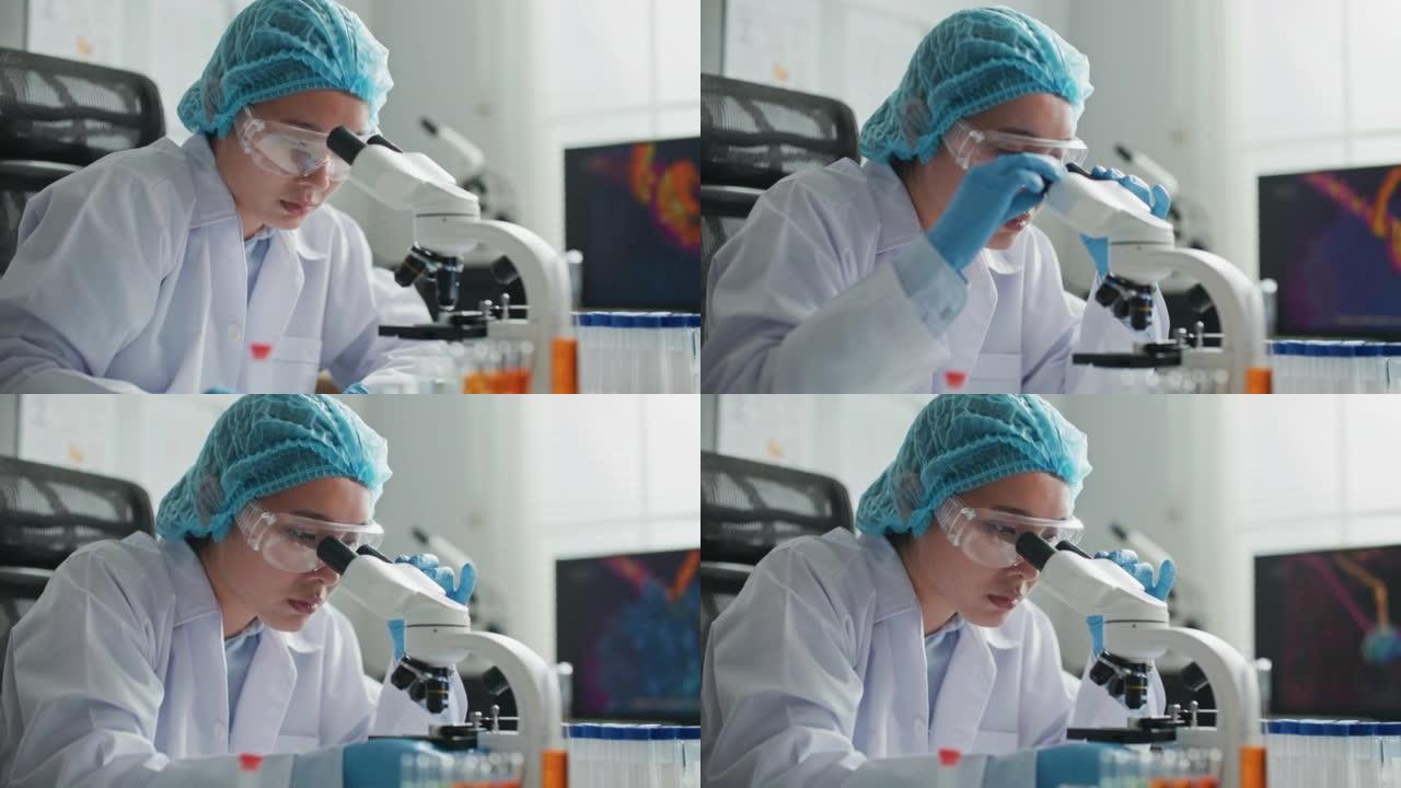 医学科学实验室科学家在显微镜下观察