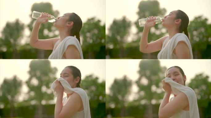 运动女子在日落高强度锻炼后喝水补水