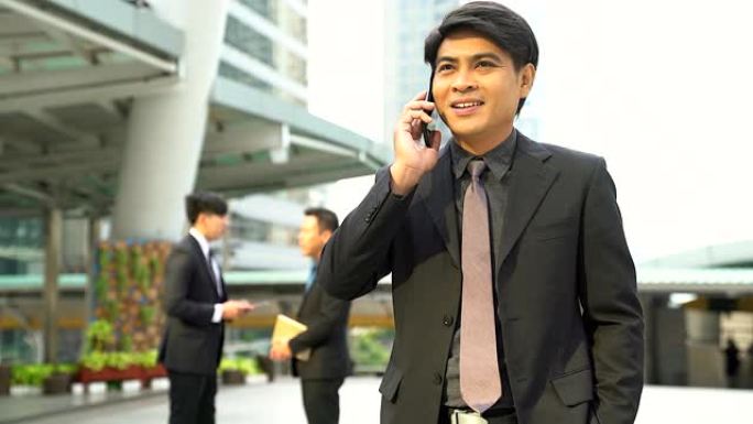 手里拿着手机在电话里聊天的商人可以在商务交流中使用图像