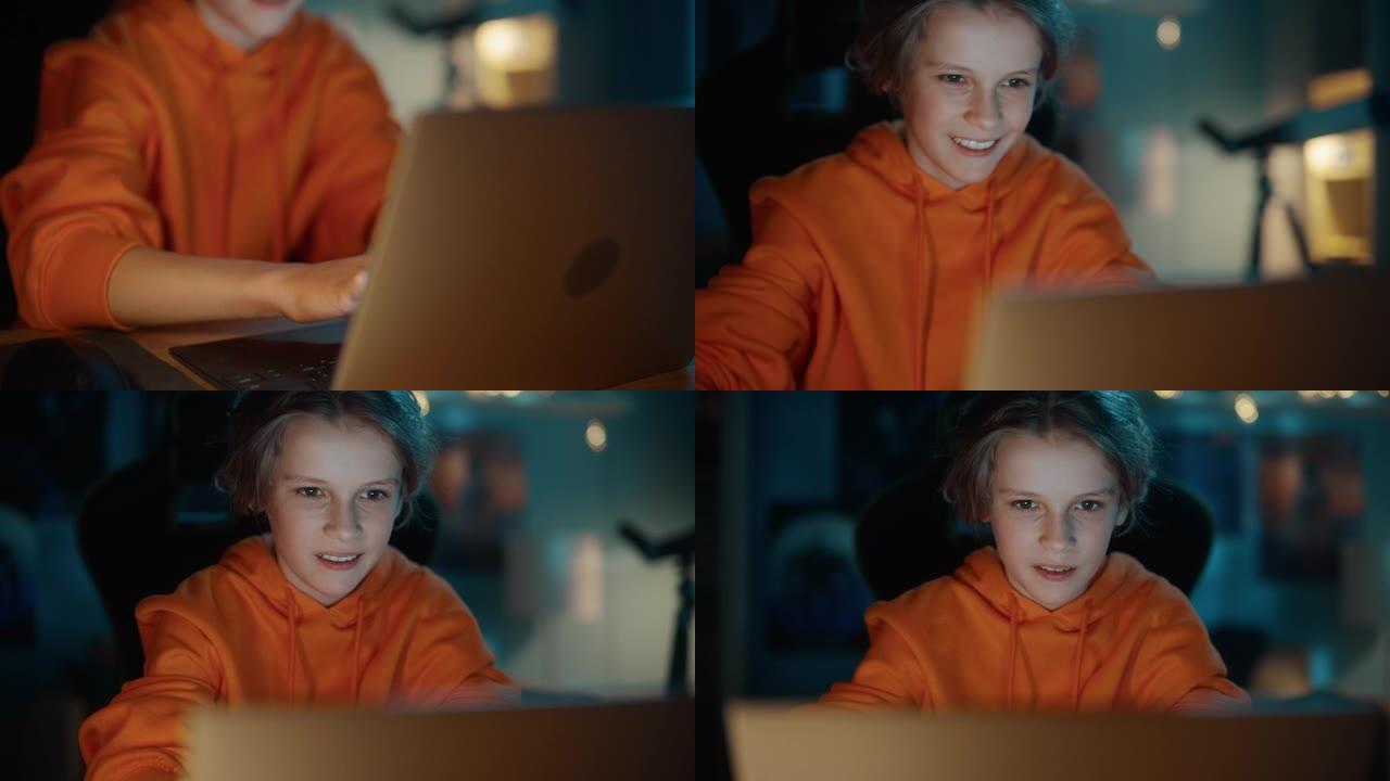 在家里舒适的黑暗房间里，一个聪明的小男孩使用笔记本电脑的特写肖像。快乐少年在线浏览教育研究，与朋友聊