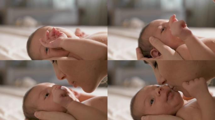 新生婴儿的慢动作肖像在母亲的怀抱中安静地休息，母亲Leens亲吻他。新来做母亲的女人表达对孩子的无条