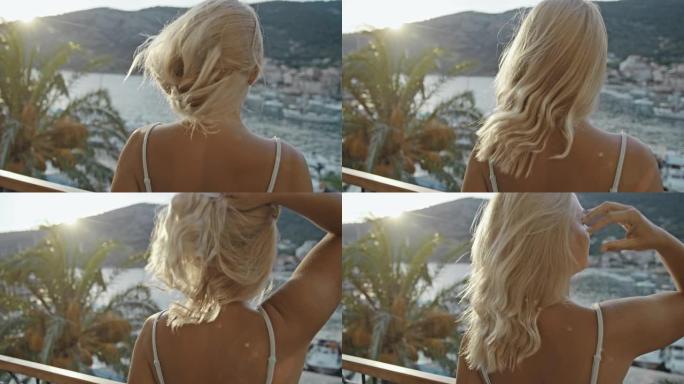 SLO MO女人在海边的阳台上散开头发
