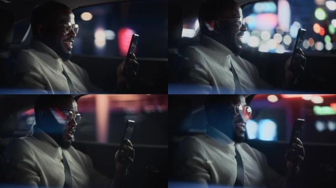 时髦的戴眼镜的黑人在晚上坐出租车的后座上下班。英俊的男性在带有工作霓虹灯的城市街道上的转车上，在智能