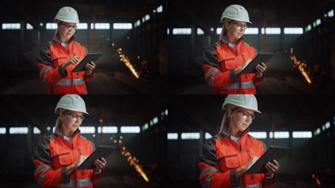 专业重工业工程师/穿着安全制服和安全帽的工人使用平板电脑。严重成功的女性工业专家站在金属制造仓库。