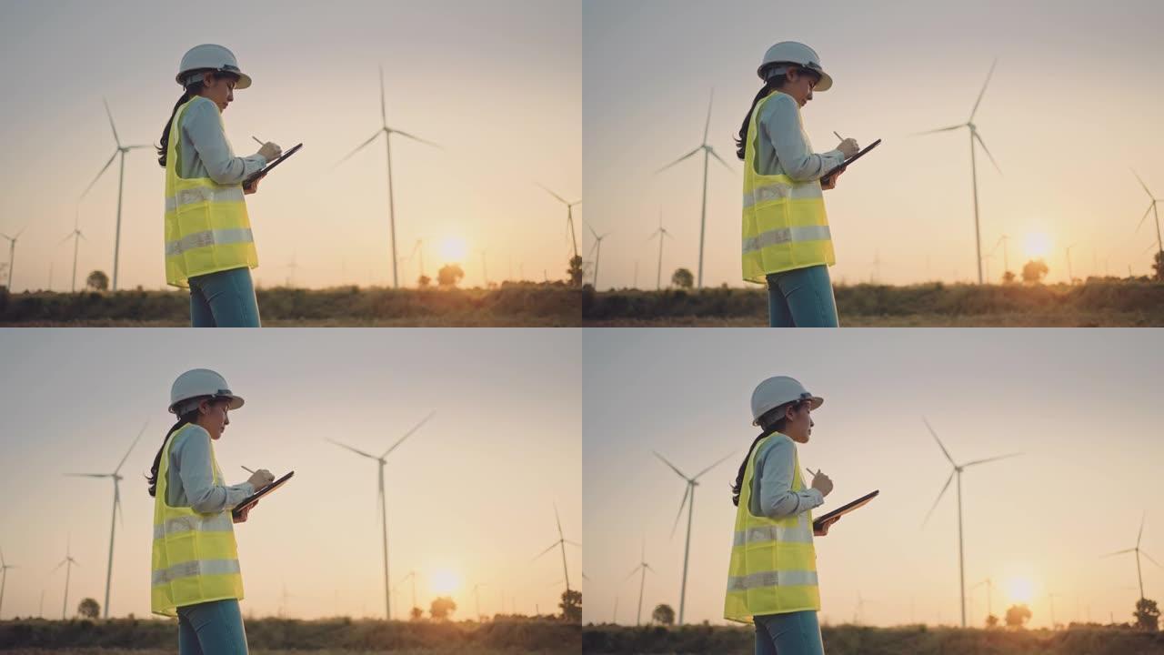女工程师在外面工作以控制风力涡轮机的能量