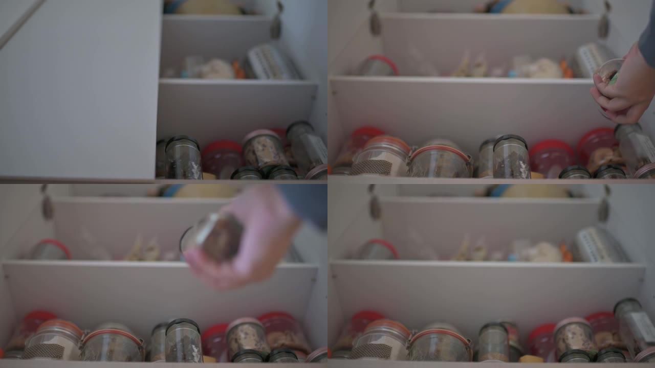 低角度视角亚洲中国男性从厨房货架柜取回食品瓶