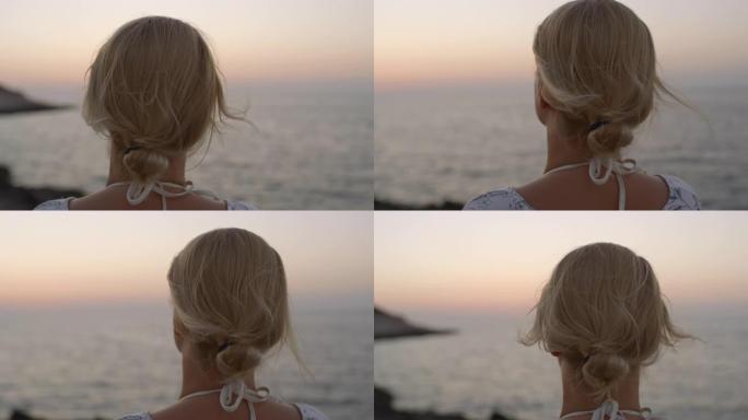 克罗地亚亚得里亚海日落时欣赏海景的CU宁静年轻女子