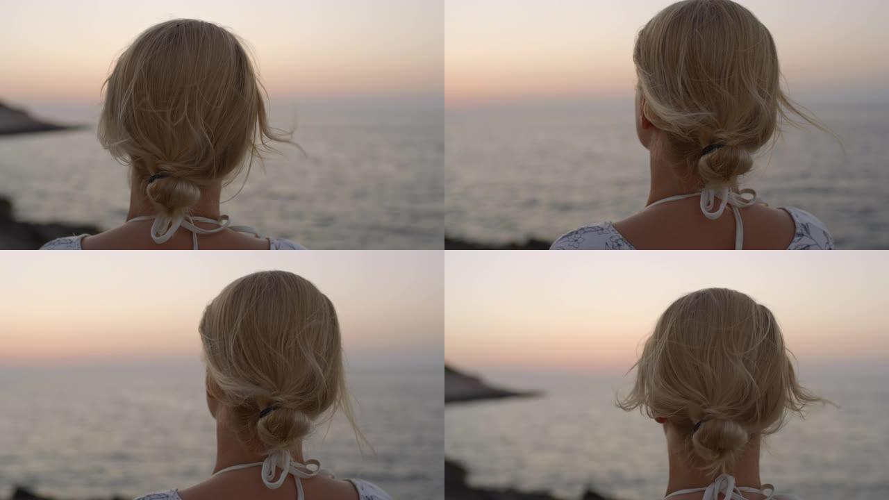 克罗地亚亚得里亚海日落时欣赏海景的CU宁静年轻女子