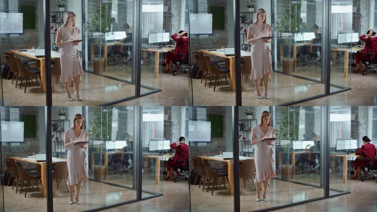 现代办公室: 美丽的创意专家肖像穿着华丽的连衣裙，手持数字平板电脑。致力于应用程序设计、数据分析、社