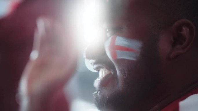 体育馆体育赛事: 英俊的黑人特写肖像，为红队获胜欢呼，尖叫着庆祝胜利。国际锦标赛，世界杯