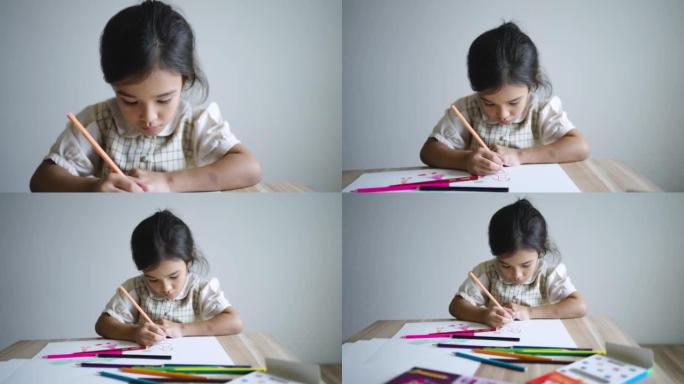 小女孩在绘图本上画画