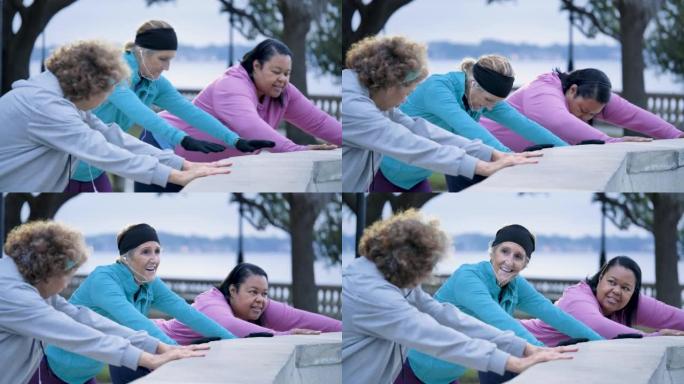 三名多种族妇女在公园锻炼，伸展运动