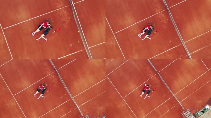 一对夫妇躺在网球场上接吻的俯视图
