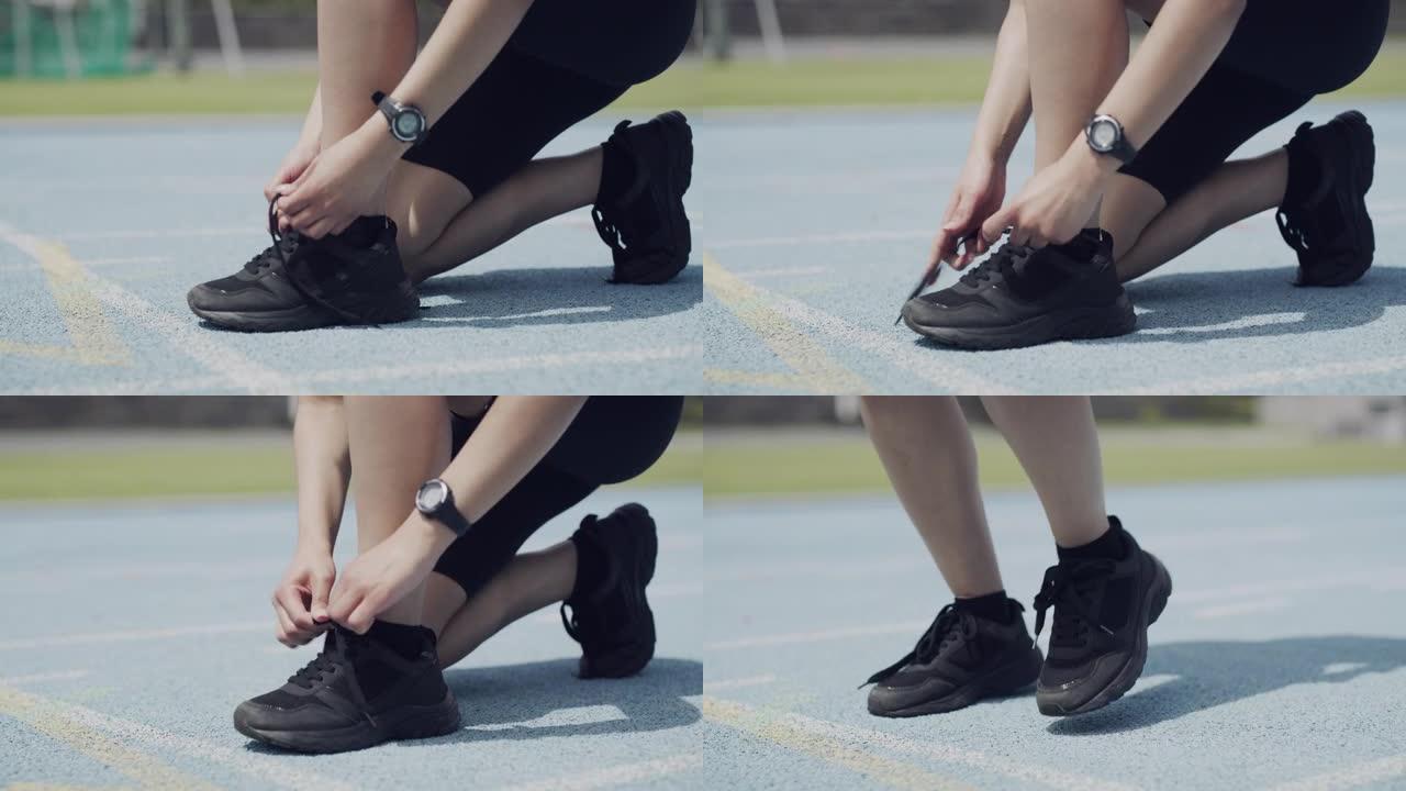 4k视频片段，一名无法识别的女运动员在赛道上系鞋带