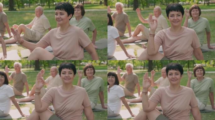 女教练在户外与老年人一起练习瑜伽