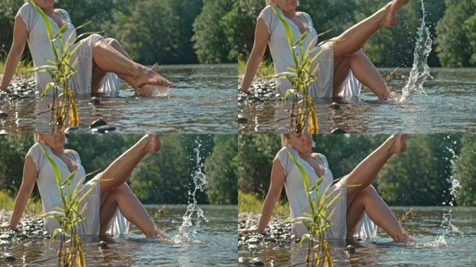 超级SLO MO Mid成年女子在河上泼水
