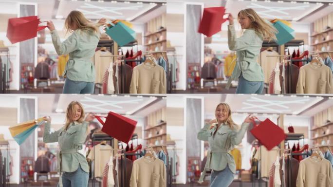 一个快乐的女性带着购物袋在服装店微笑、跳舞和旋转的肖像。年轻的成年金发白人女性顾客在百货商店购买时装