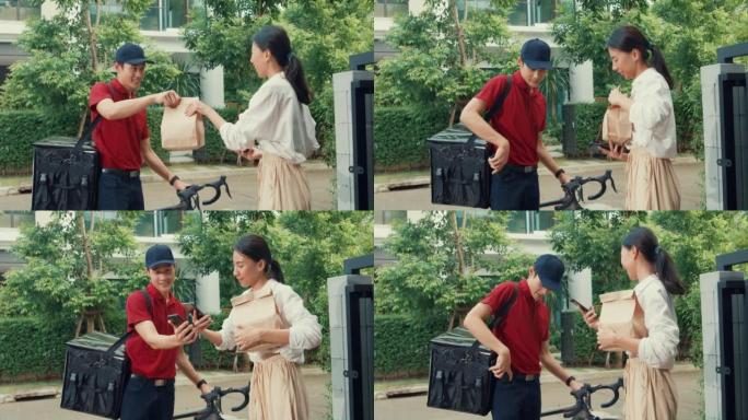 年轻的亚洲送货员，穿着红色制服的自行车，随身携带箱子敲门家庭网上购物纸袋给门前的女人，女士在家里用智