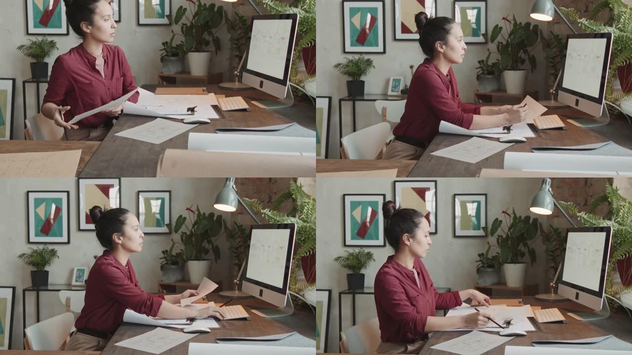在计算机上处理草图的女建筑师