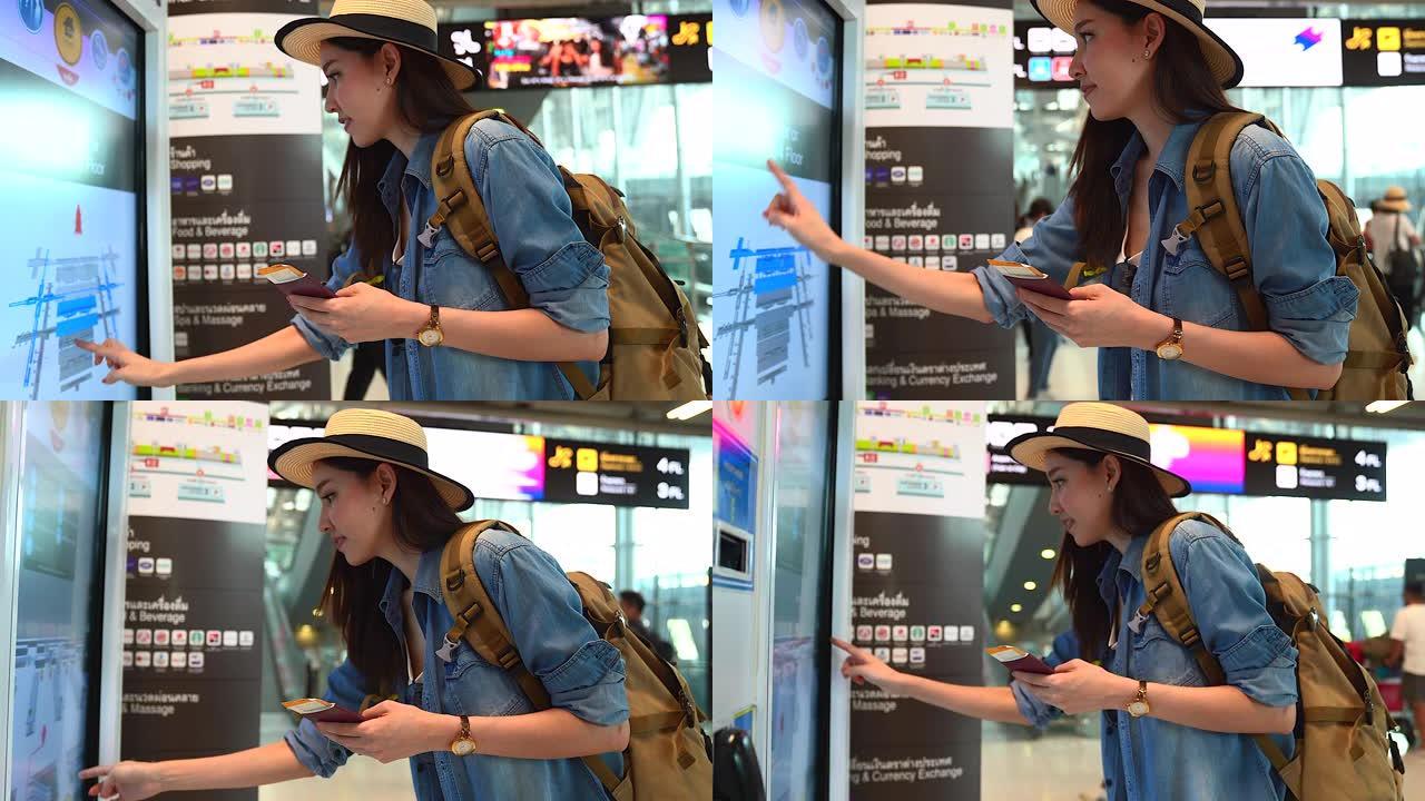 穿着旅游服的亚洲美女，检查有关航班时刻表的登机信息。出国旅行可以用于代表独自旅行的概念工作中。
