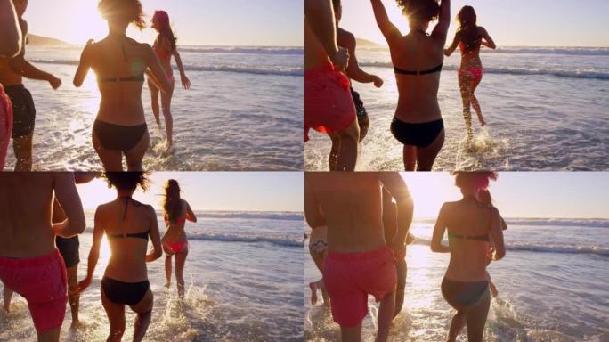 一群无法识别的朋友在日落时在海洋中建立联系和玩耍的4k视频片段