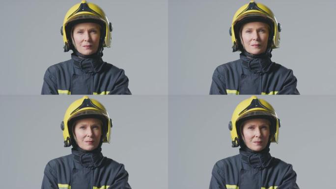 工作室肖像严肃的成熟女消防员戴着头盔，背景素色