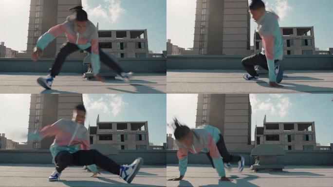 跳舞的人跳翻筋斗霹雳舞在城市的屋顶上练习舞蹈套路