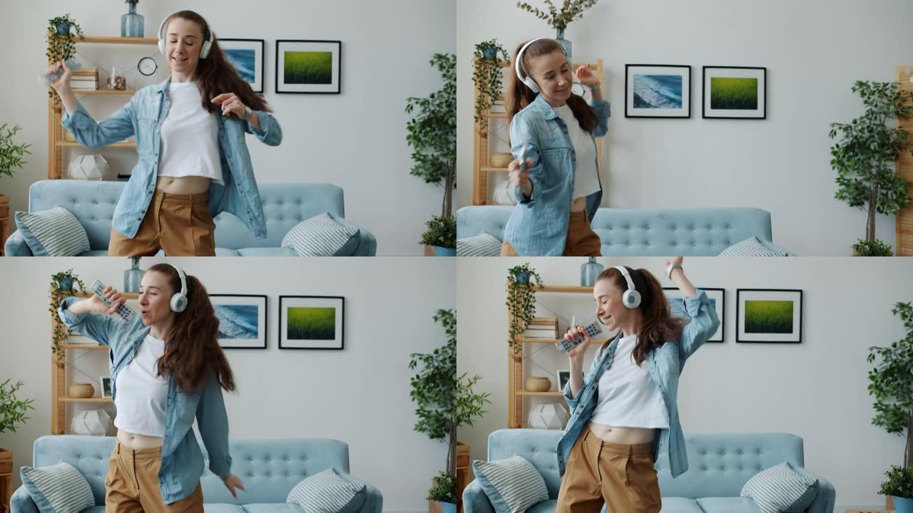 顽皮的女学生在遥控器中唱歌，在家里用耳机听音乐跳舞