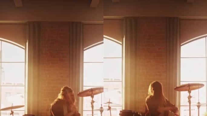 垂直屏幕: 富有表现力的鼓手女孩在充满灯光的阁楼音乐排练室里打鼓。摇滚乐队音乐艺术家学习新鼓独奏。