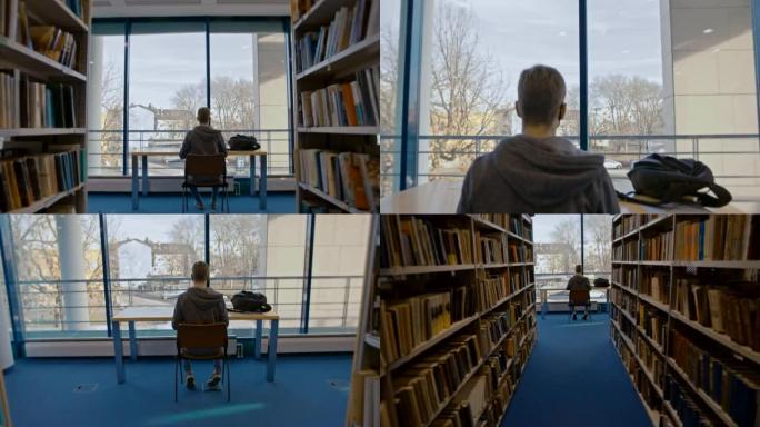 SLO MO学生在图书馆书籍过道尽头的桌子上使用笔记本电脑