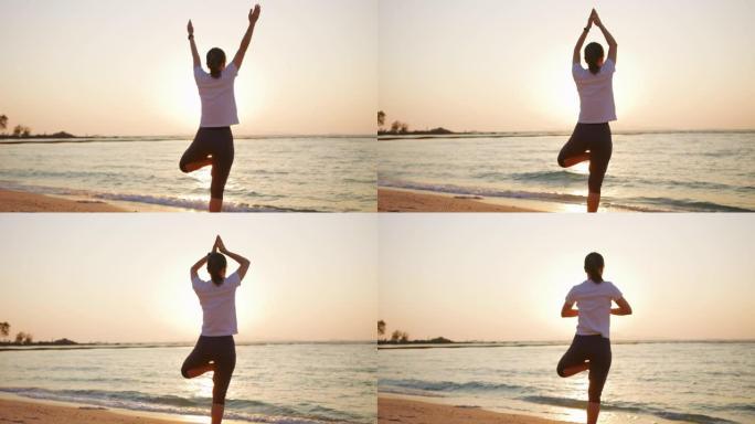日落时坐在沙滩上做瑜伽的女人