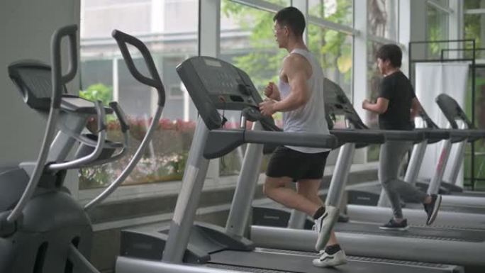 亚洲中国运动员在健身房跑步跑步机