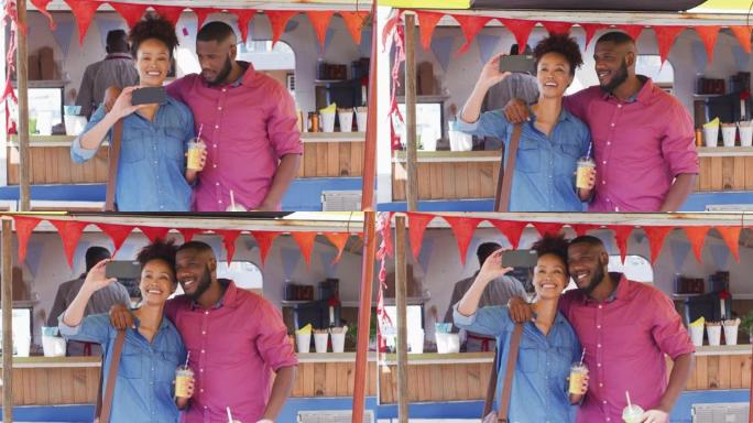非洲裔美国夫妇拿着冰沙微笑着在餐车上自拍