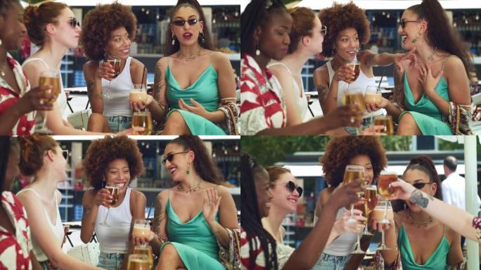 不同的女性朋友在夏季旅行中庆祝和欢呼快乐的回忆。一群多民族妇女在露天酒吧举杯为友谊干杯