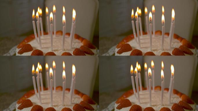 宏观: 蜡烛在美味的草莓椰子生日蛋糕上燃烧。