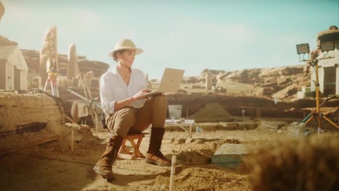 考古挖掘现场盘古: 美丽的女考古学家做研究，用笔记本电脑，分析出土的古代文明文化文物。发掘现场的伟大
