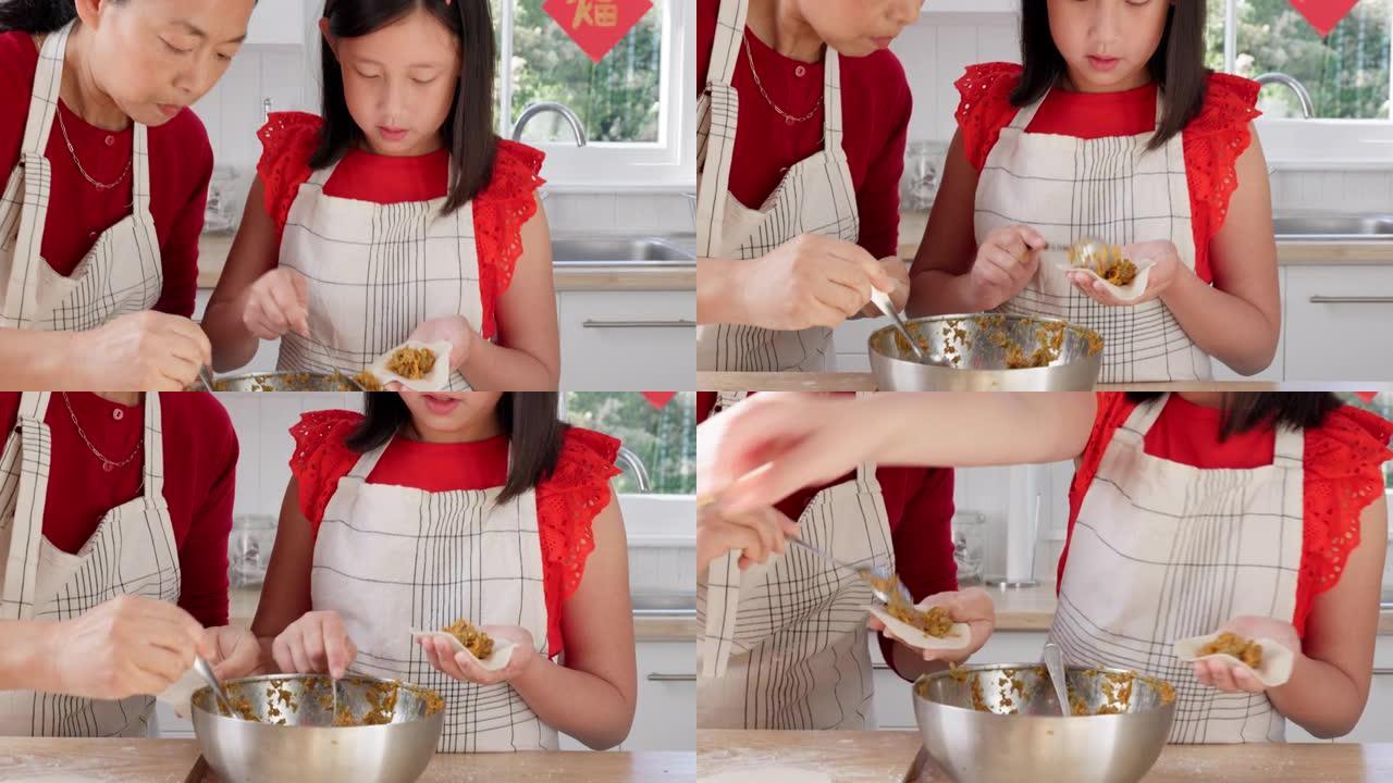 母亲教孩子在家里的中国假期在厨房做饭。妈妈和女儿在中国的家中一起做传统的晚餐，参加聚会或活动。