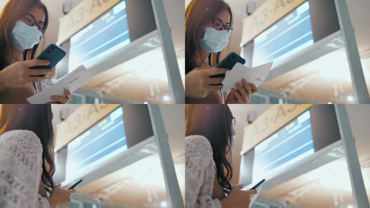 在机场航站楼使用智能手机的年轻亚洲妇女