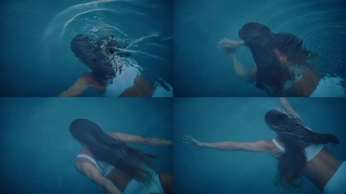 女人在豪华度假胜地的游泳池里水下游泳