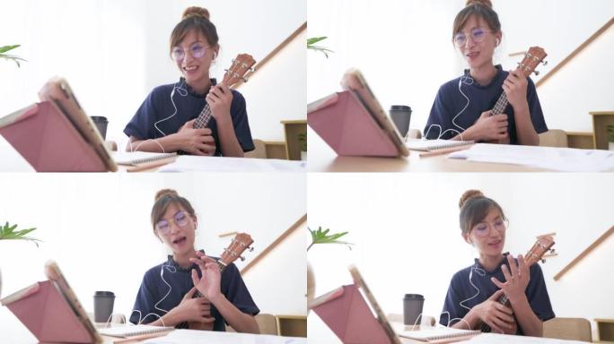 快乐的亚洲女性在家在线教授四弦琴