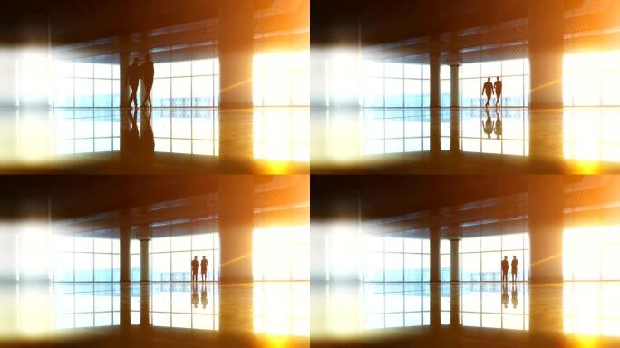 男人和一个女人在阳光明媚的背景下走在办公中心
