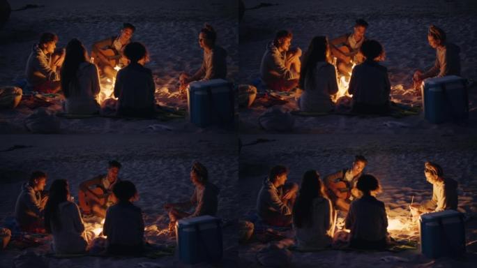 4k视频片段，一群不同的朋友围坐在火炉旁，日落时在海滩上结伴