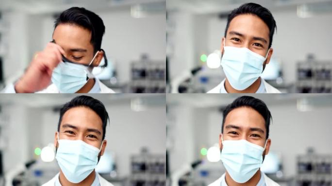 在实验室里戴着口罩和防护眼镜的快乐男科学家。一位年轻的医疗保健专家的肖像，对找到治愈方法充满信心。开
