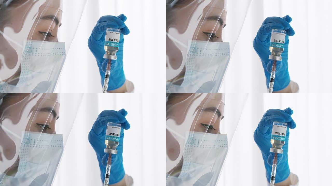 医生或研究人员用口罩握住并填充疫苗到注射器的近手。带口罩的医疗用疫苗填充注射器。Covid19在注射
